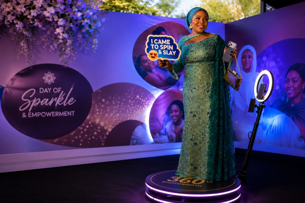 glowing circular 360 photobooth event space with guest posing
